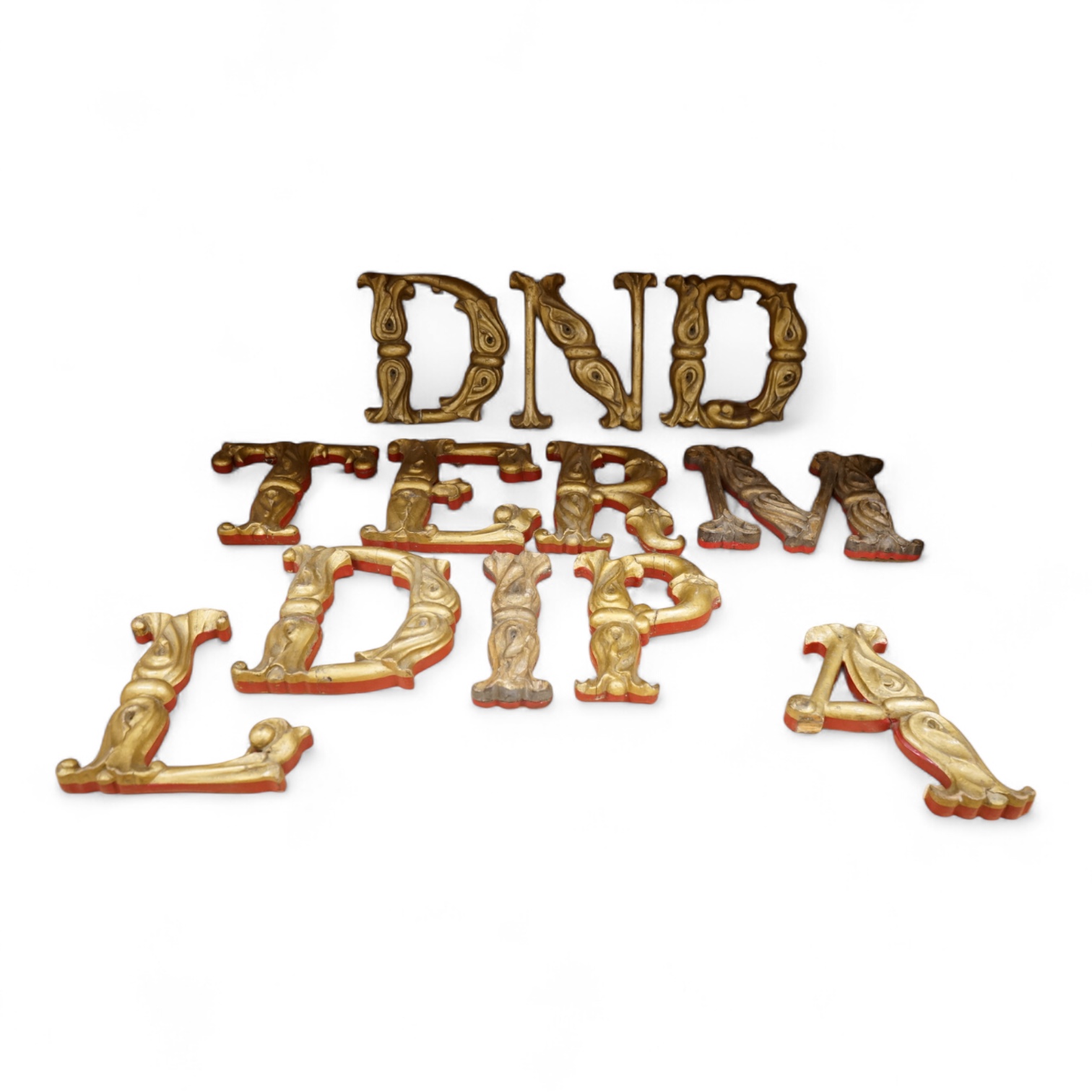 A quantity of decorative carved, painted and gilt carnival letters, each approximately 23cm high
